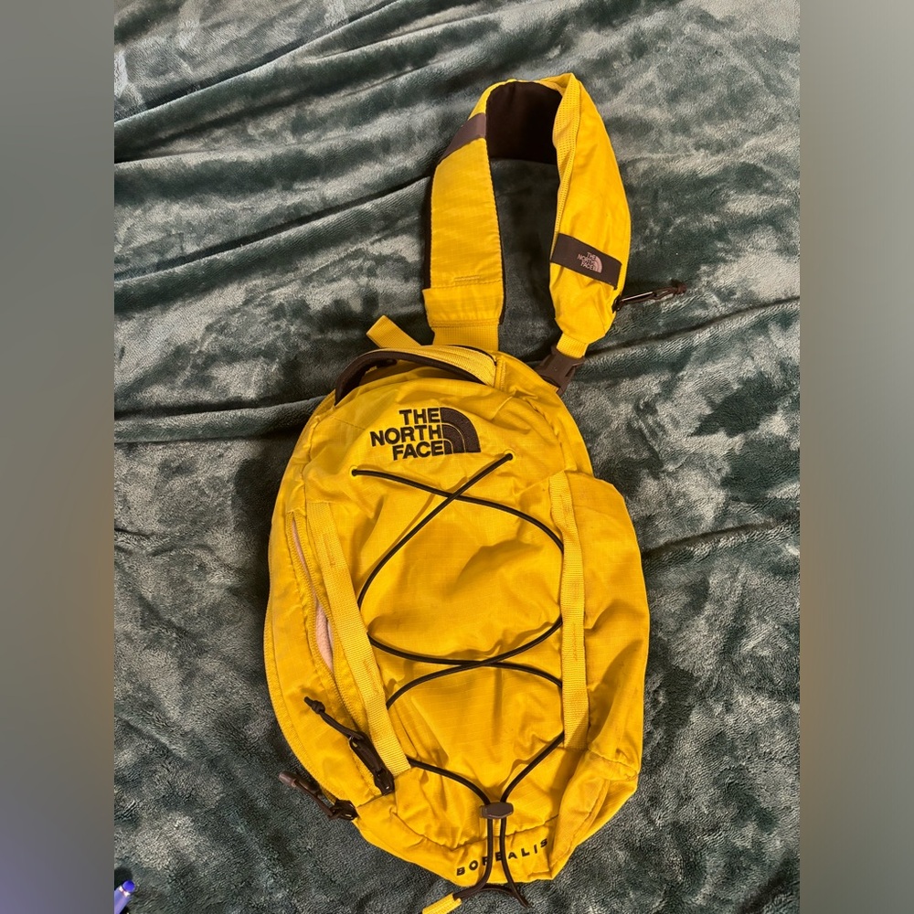 Yellow and black North Face sling bag $25